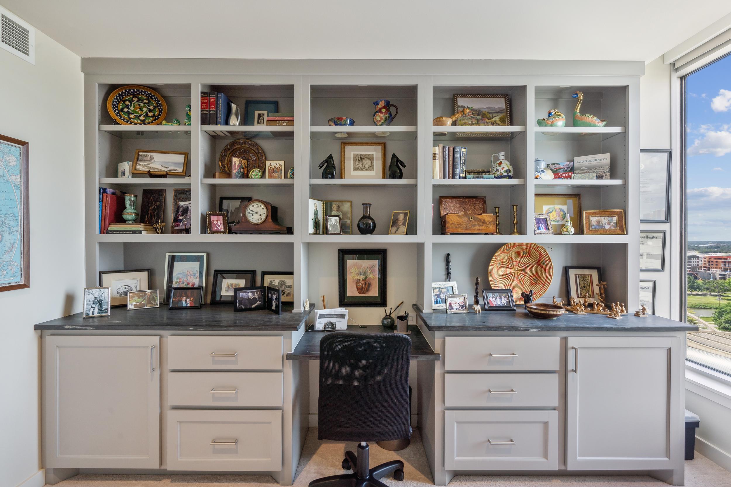 A den in the Leon floor plan with an intricate shelf full of trinkets.