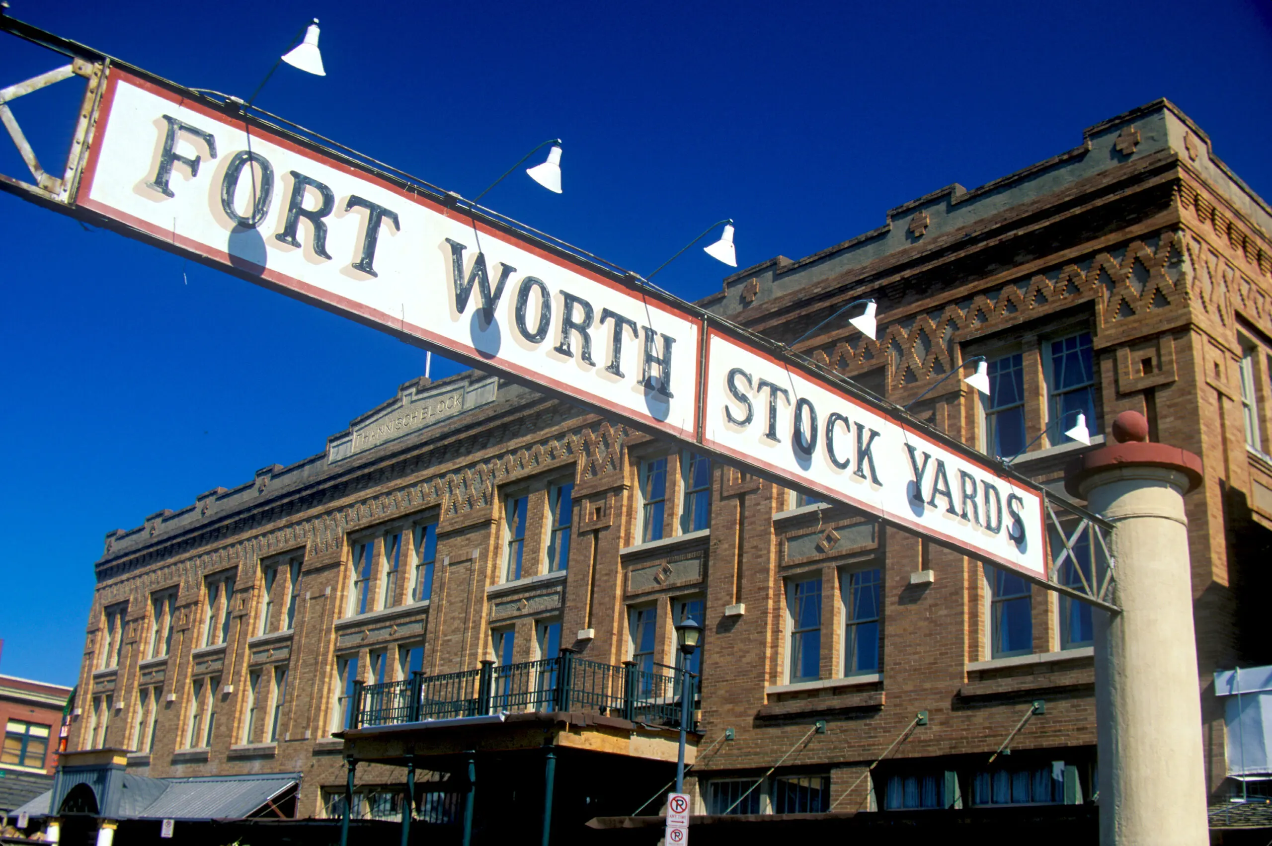 Banner at the Fort Worth Stock Yards with historic hotel, Ft. Worth.