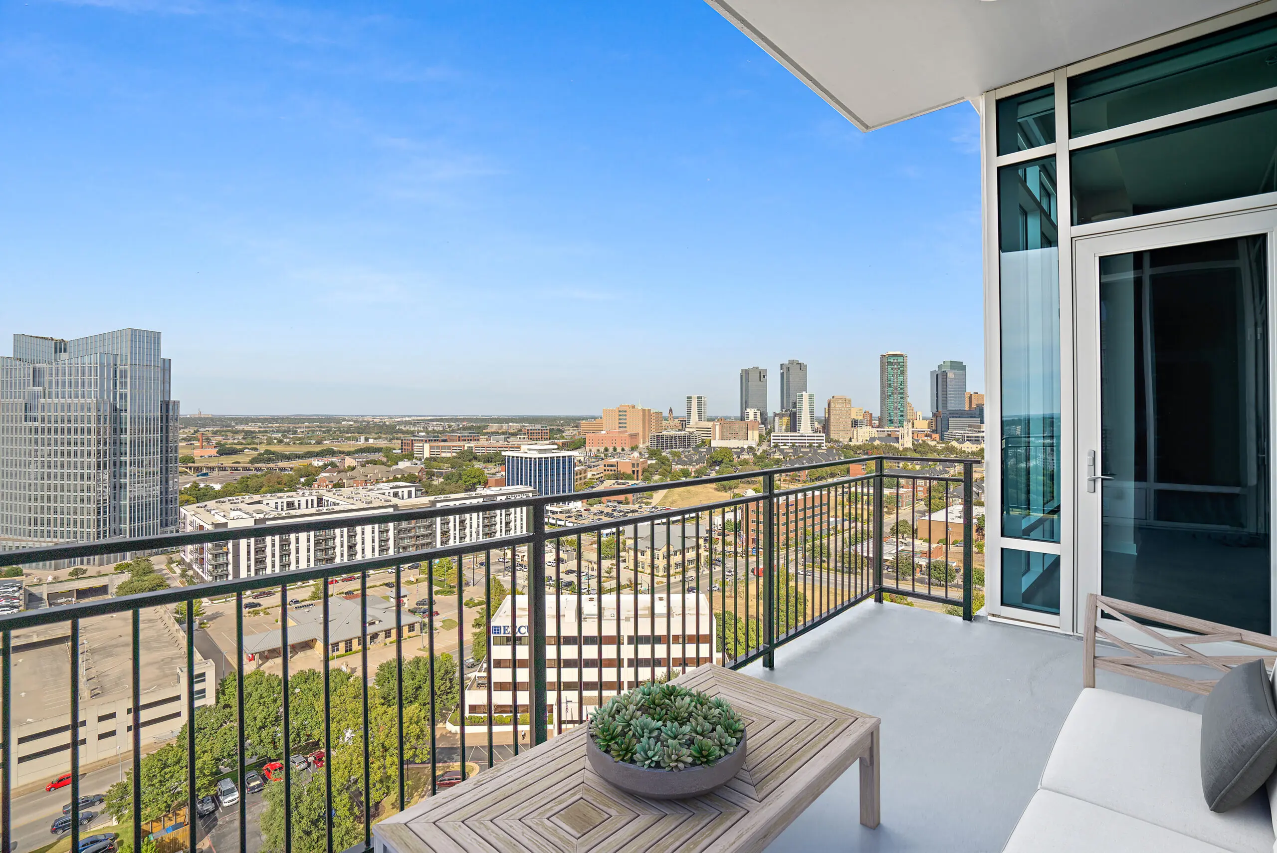 A balcony with a seating area in a Trinity Terrace residence.
